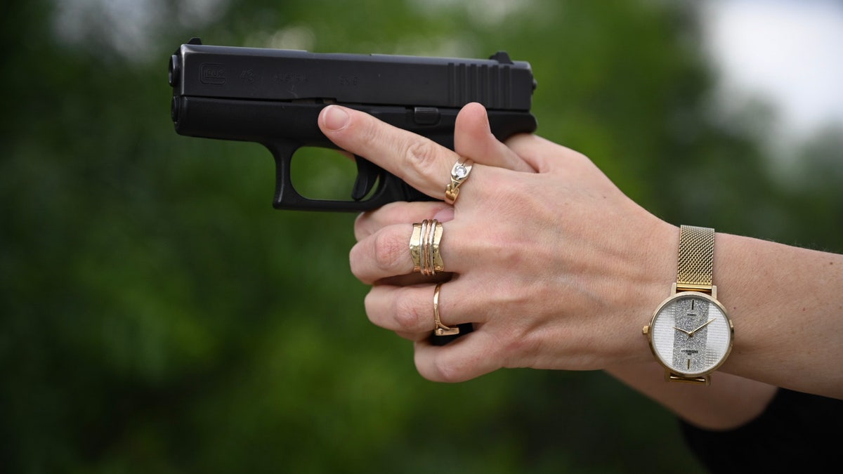 Woman aims handgun