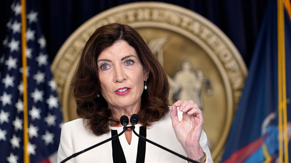 A close-up of Kathy Hochul speaking at a podium