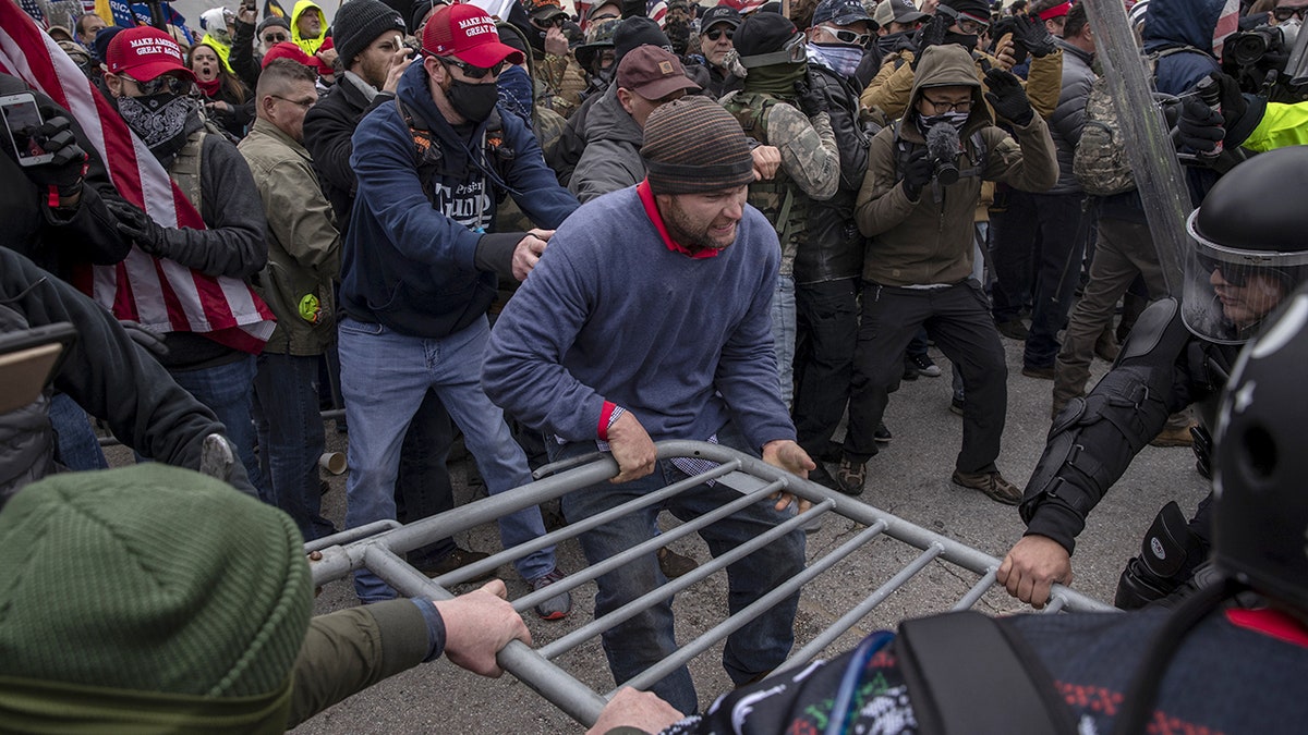 Demonstrators, police fight over barricade during Jan. 6 Capitol riots