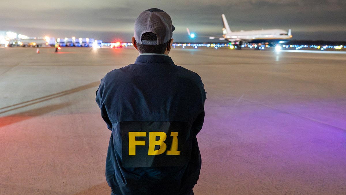 FBI Director Kash Patel is seen waiting for an extradition flight that was carrying Muhammed Sharifullah.