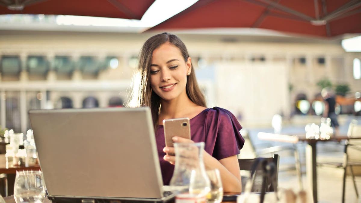 woman with computer and phone