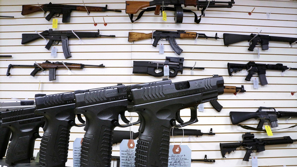 guns displayed on wall and on table