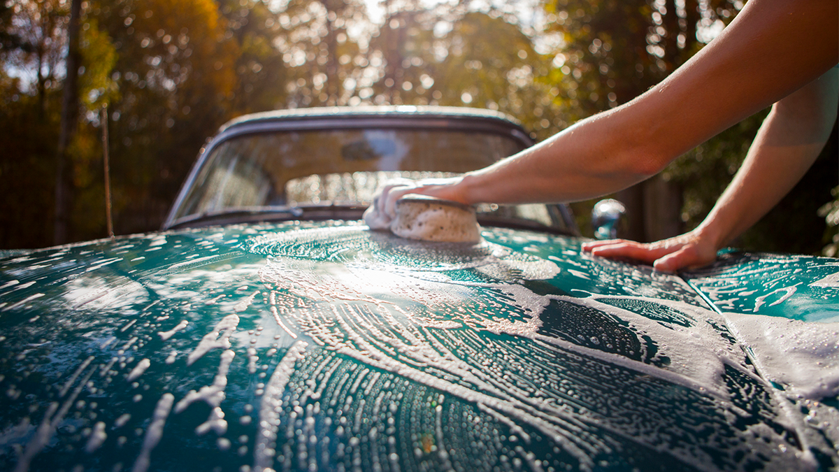 Woman washing a car