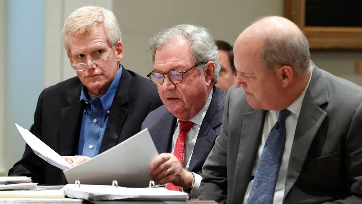 Alex Murdaugh sits in the Colleton County Courthouse with his legal team including Dick Harpootlian, middle, and Jim Griffin, right, as his attorneys discuss motions in front of Judge Clifton Newman in a December 2022 hearing