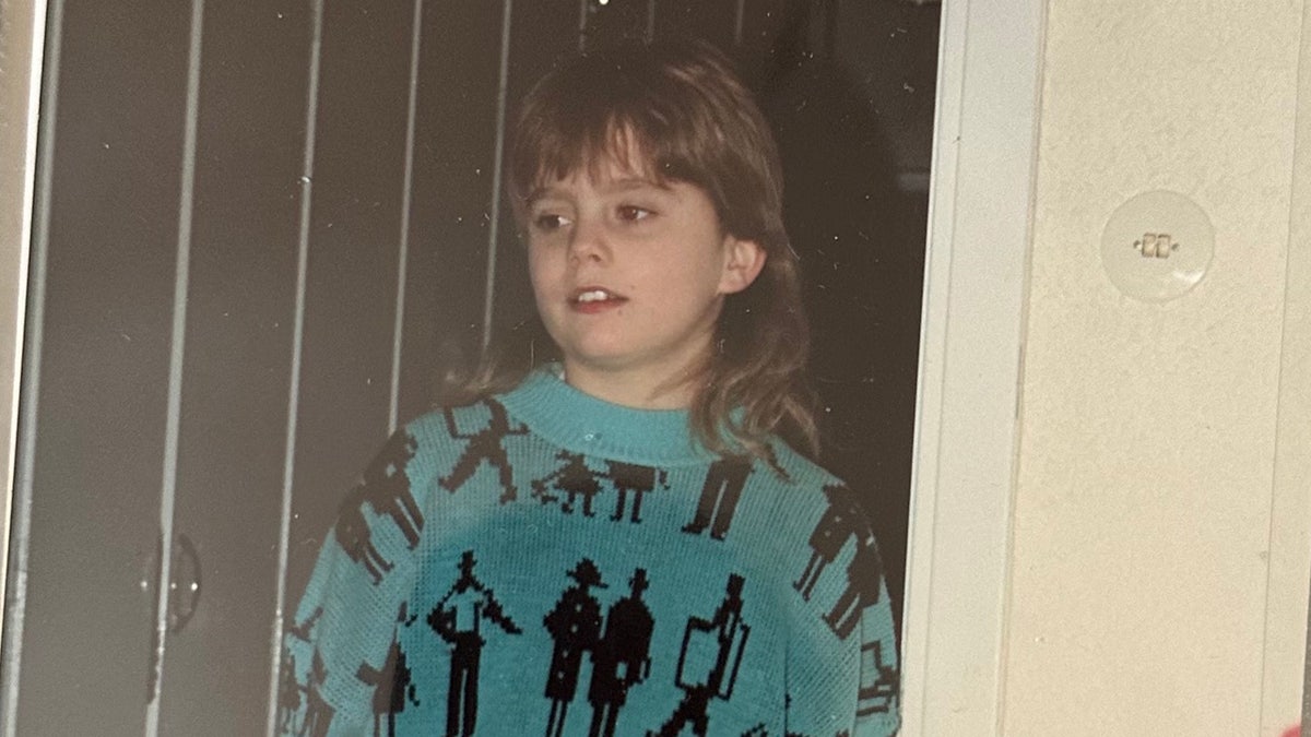 A young Isakin Jonsson wearing a blue and black printed sweater.