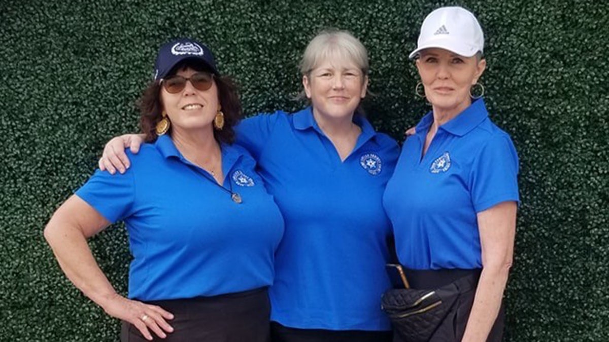 The Bakersfield 3 Moms posing together and smiling while holding each other.