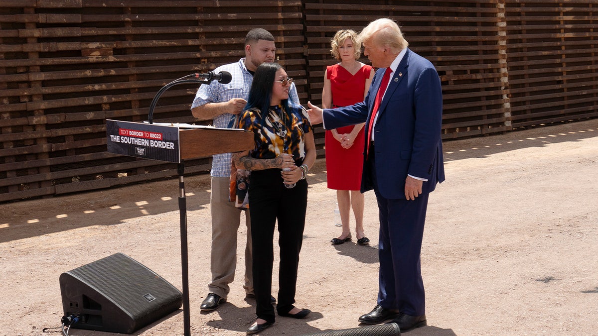 U.S. Republican Presidential Candidate and former President Donald Trump comforts Alexis Nungaray, mother of Jocelyn Nunagaray who was killed by undocumented migrants, at the U.S.-Mexico border fence on August 22, 2024 south of Sierra Vista, Arizona.