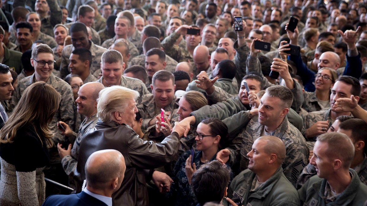 President Donald Trump greets members of the military after speaking at a hanger rally at Yokota Air Base, Sunday, Nov. 5, 2017, in Fussa, on the outskirts of Tokyo, Japan. Trump is on a five country trip through Asia traveling to Japan, South Korea, China, Vietnam and the Philippines. (AP Photo/Andrew Harnik)