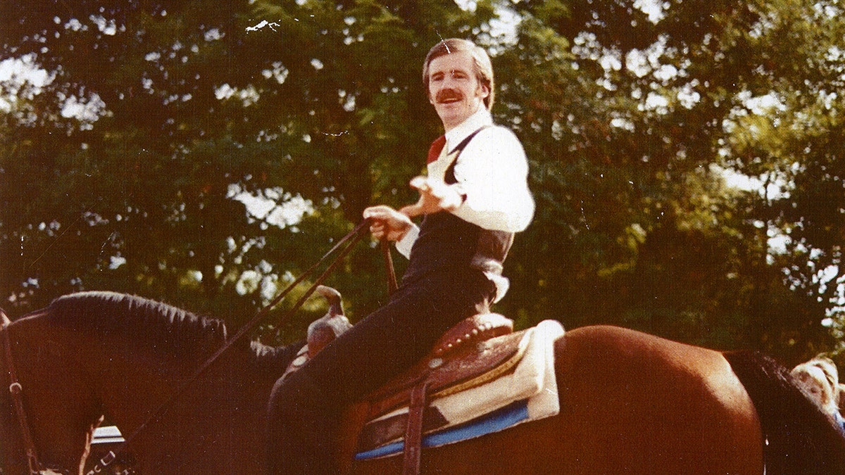 Dan Lafferty riding a horse in formal wear.