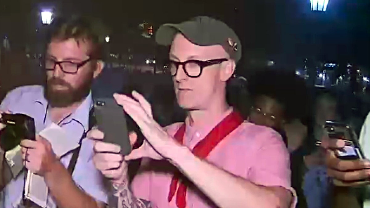 Redneck Revolt professor, Dwayne Dixon is seen shooting with an iPhone