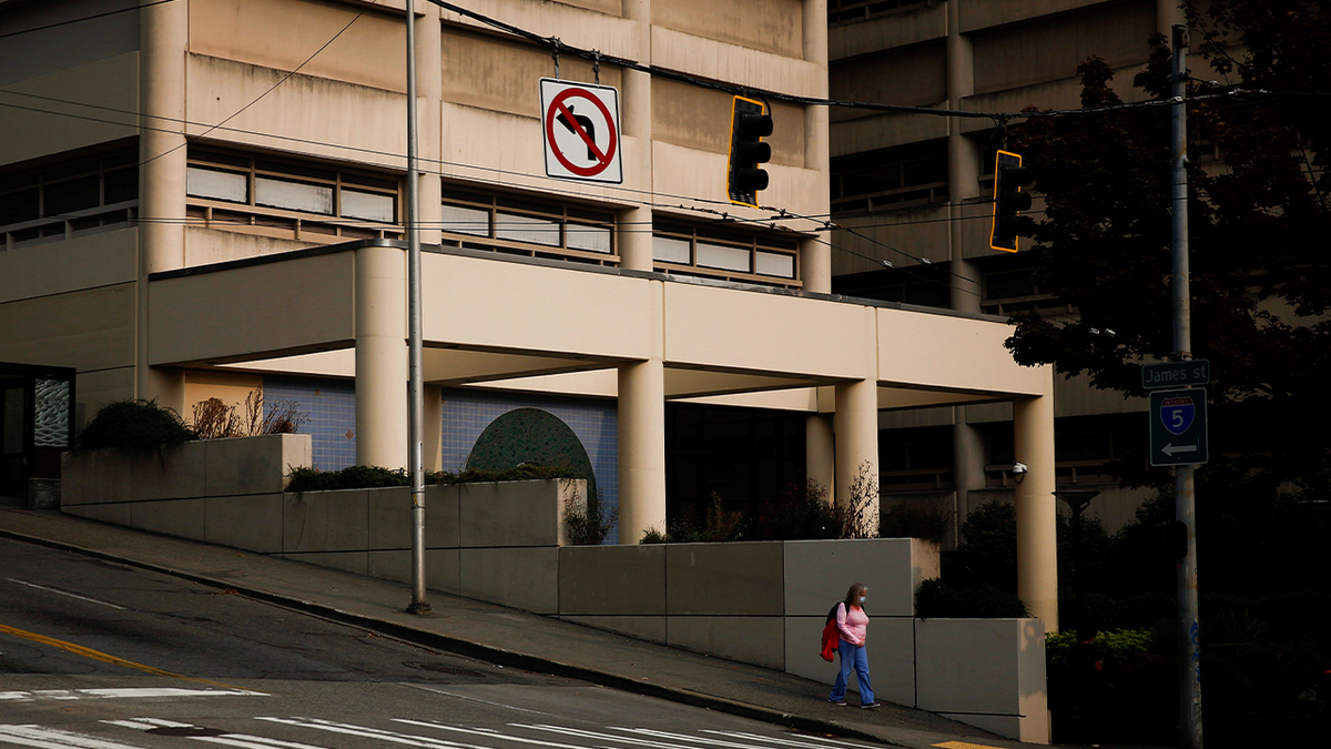 A person walks by the King County Correctional Facility in downtown Seattle