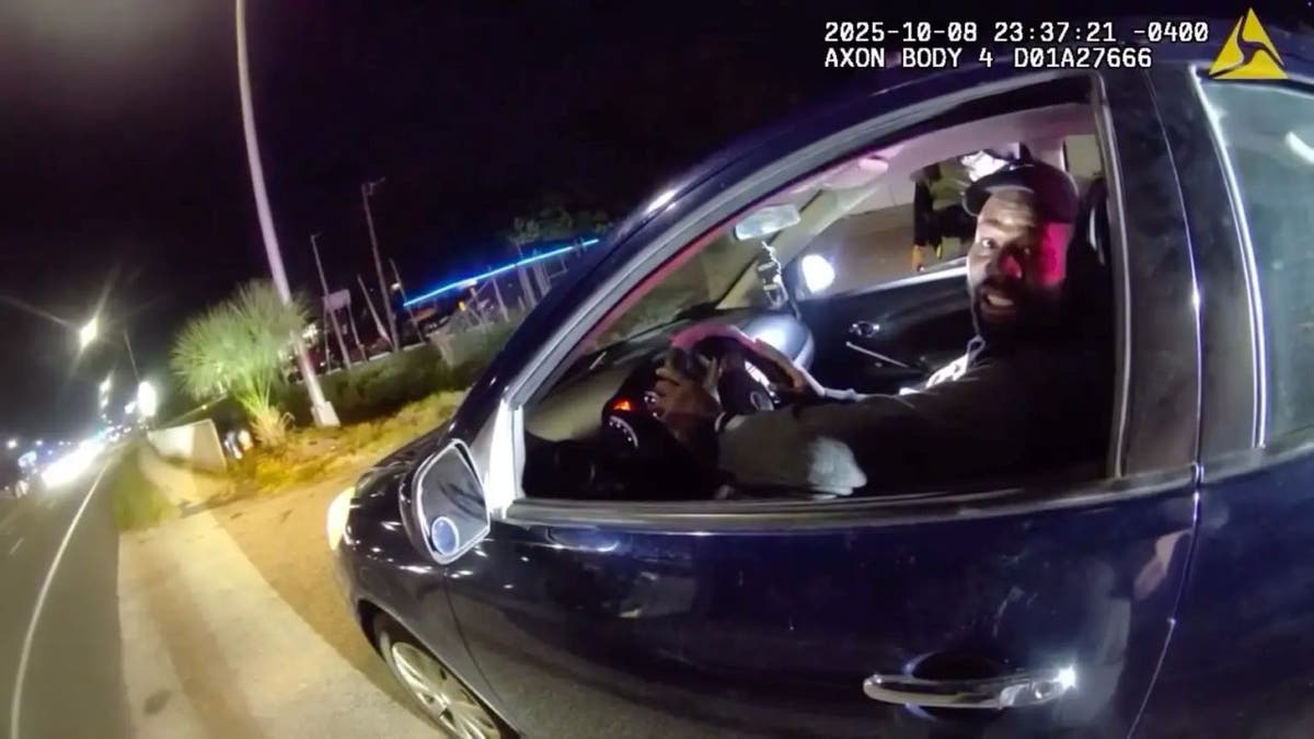 Police talks to Louis Charles at a traffic stop