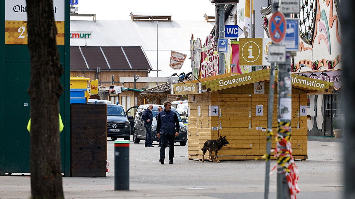 A police officer and a police dog on fair grounds