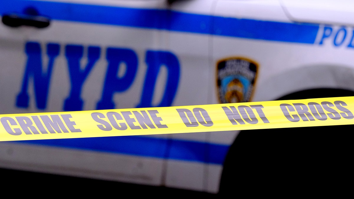 Police tape is seen outside an NYPD vehicle in New York City