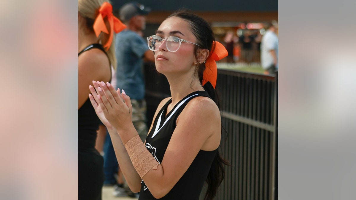 Kimber Mills cheerleading at a game