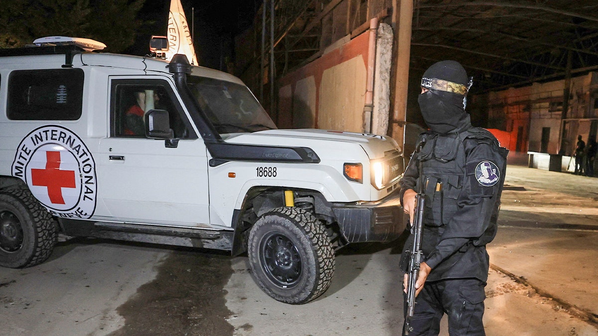 Red Cross vehicle parked next to armed guard in Gaza