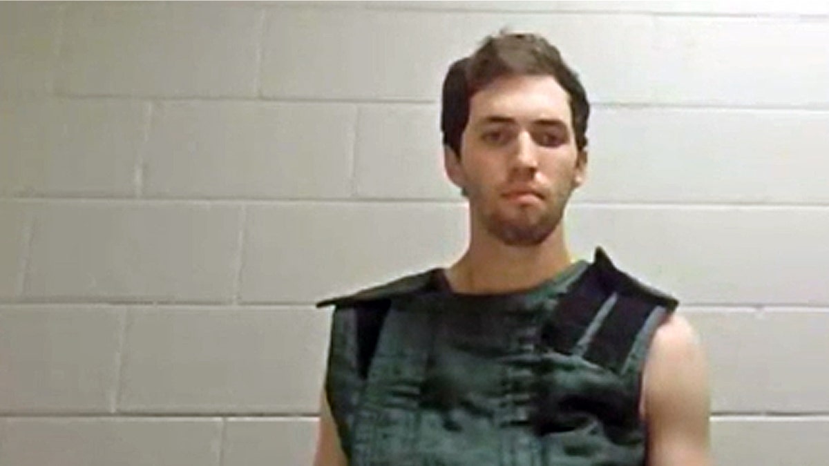 tyler robinson appears virtually in court from a utah jail wearing a green vest designed to prevent self-harm