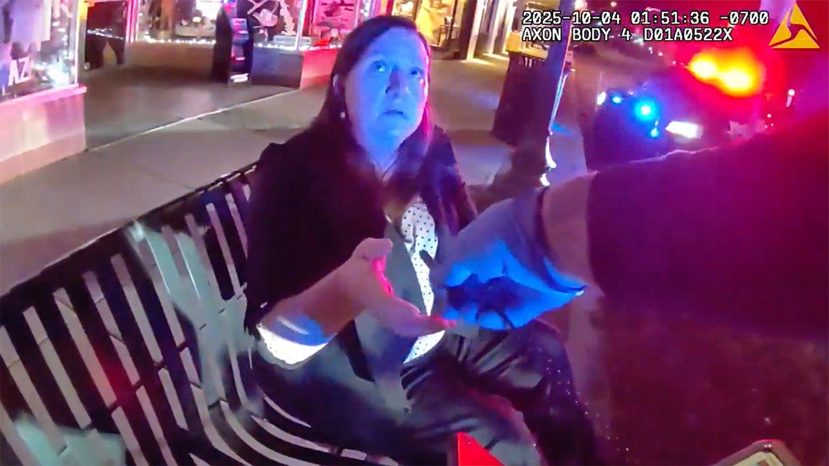 The judge reaching for a pen.