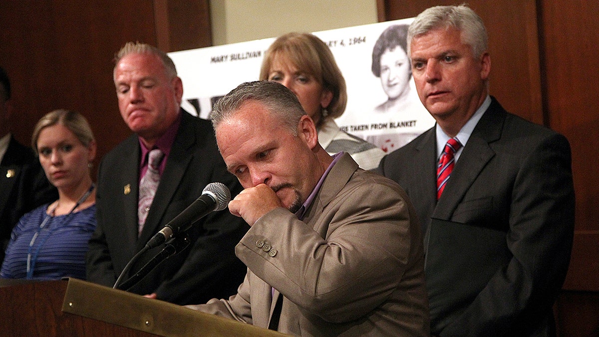 Casey Sherman crying at a podium.