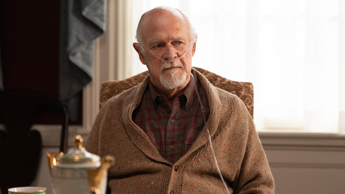 Gerald McRaney sits at a dining table wearing a brown cardigan and oxygen tubes in Murdaugh: Death in the Family episode.