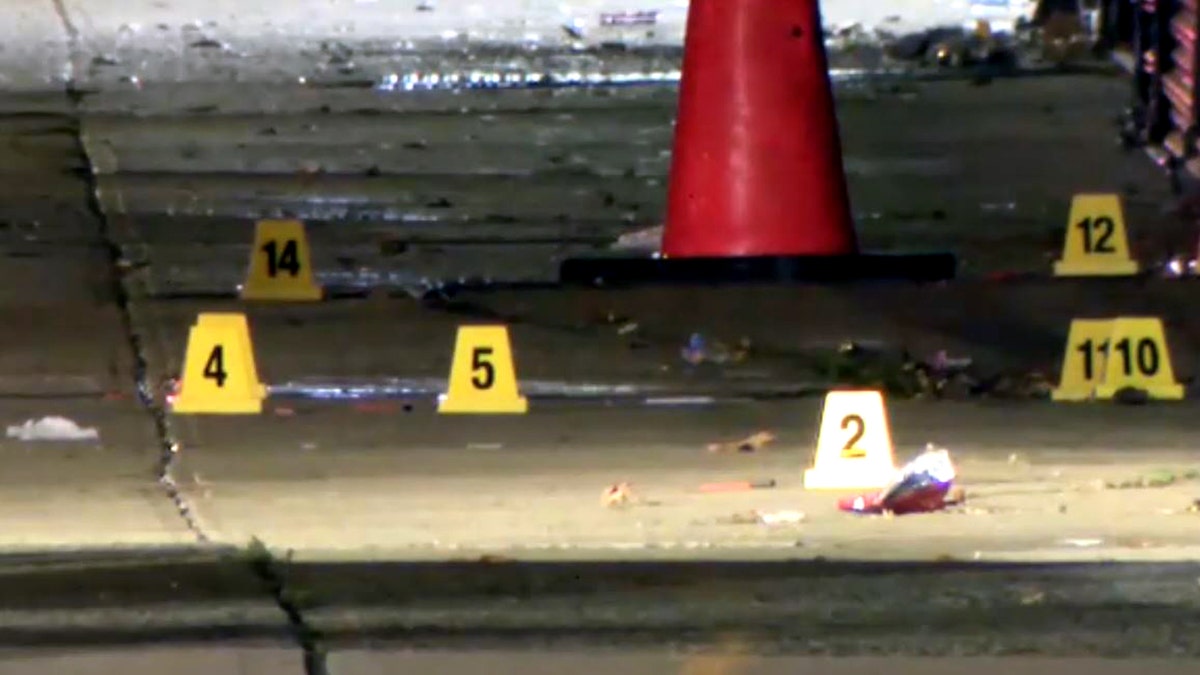 multiple yellow evidence markers placed on the sidewalk