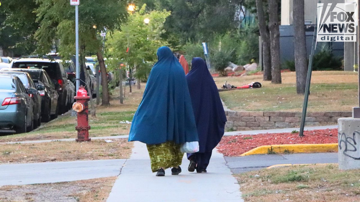Women in hijabs walking through Cedar–Riverside Minneapolis