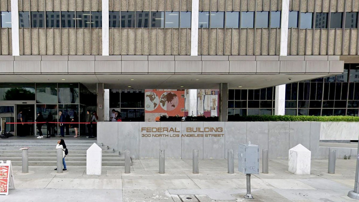 Exterior of federal building in downtown Los Angeles as people line up outside