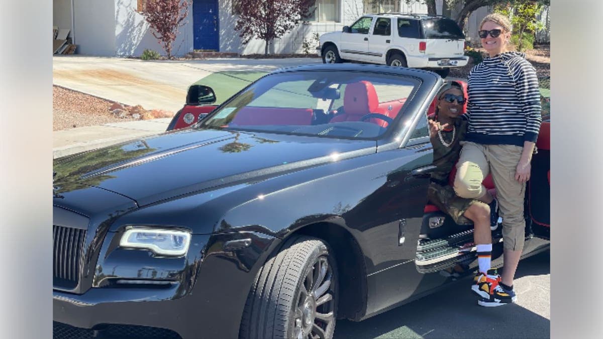 Aimee Bock standing beside a Rolls-Royce with Empress Malcolm Watson Jr. in DOJ exhibit.