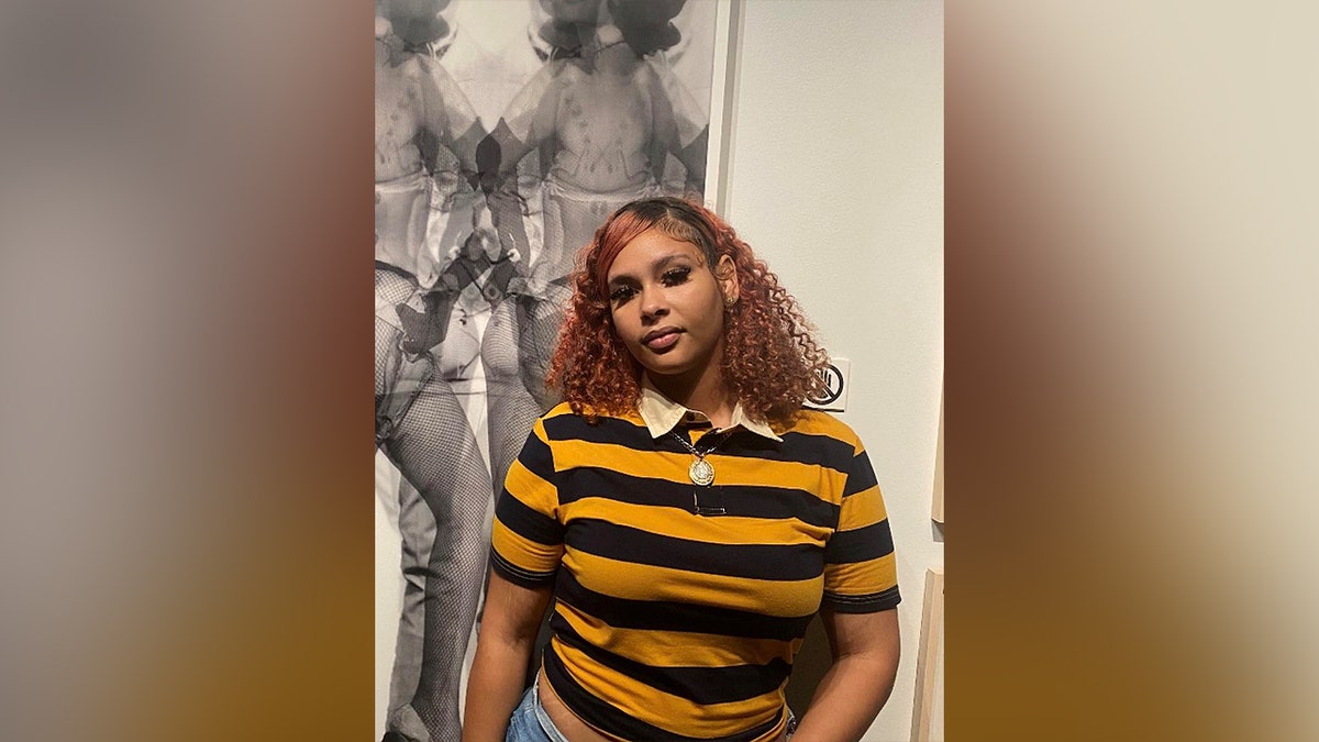 Angelique Johnson wearing a shirt with stripes.