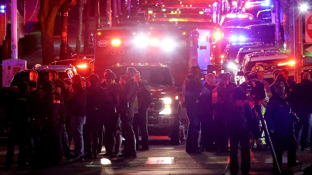 Emergency personnel gather on Waterman Street at Brown University in Providence, R.I., on Saturday, Dec. 13, 2025, during the investigation of a shooting. (AP Photo/Mark Stockwell)