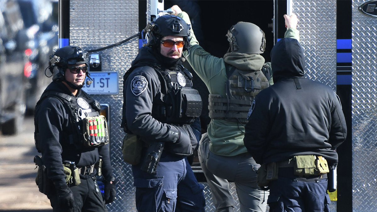 Law enforcement officers respond near a home where a decomposed body was found