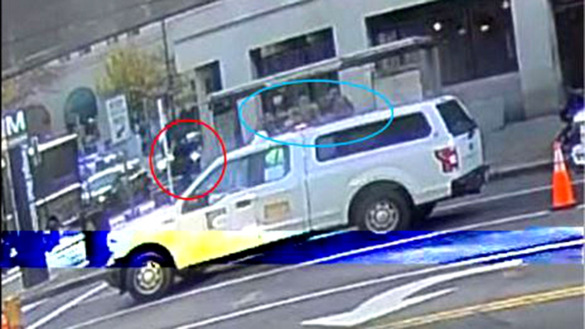 suspect appears to engage National Guard members on sidewalk