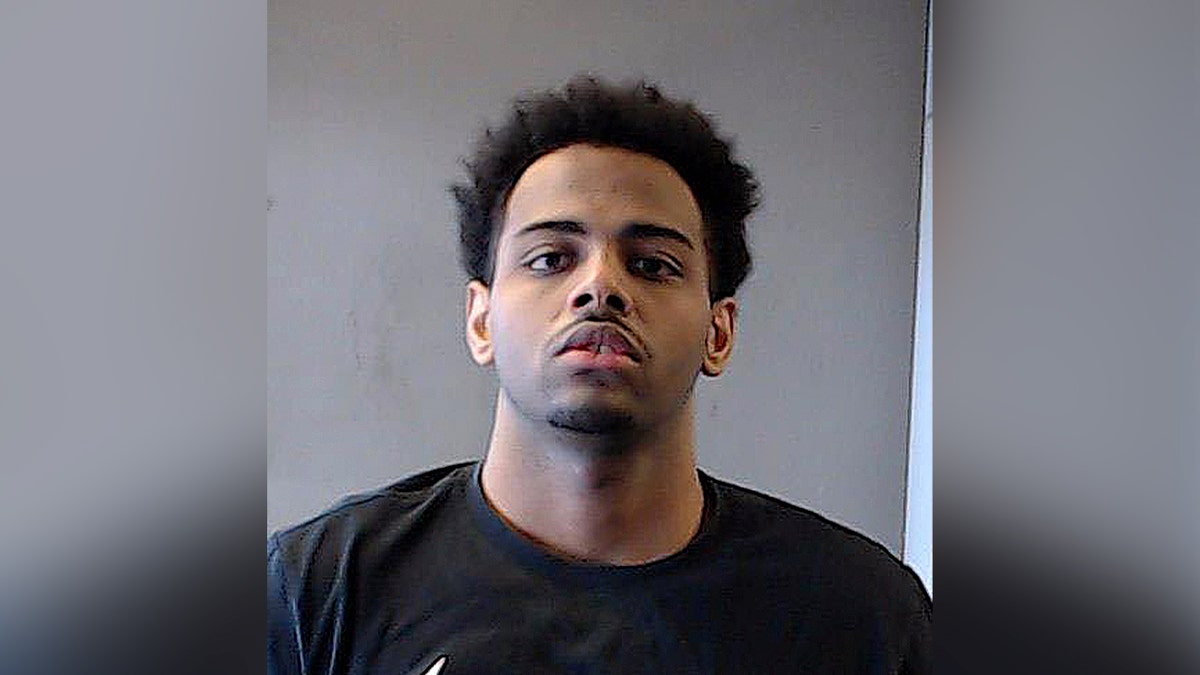 mugshot of man in black shirt