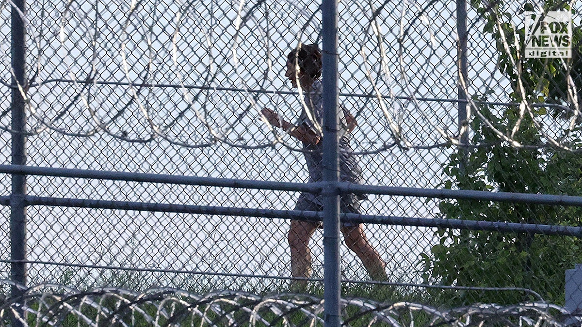 Ghislaine Maxwell is seen behind razor wire in prison