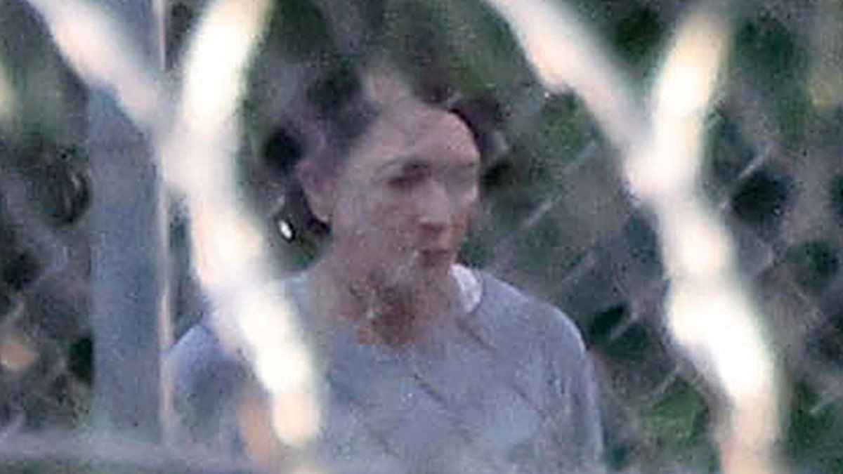 Ghislaine Maxwell is seen behind razor wire in prison