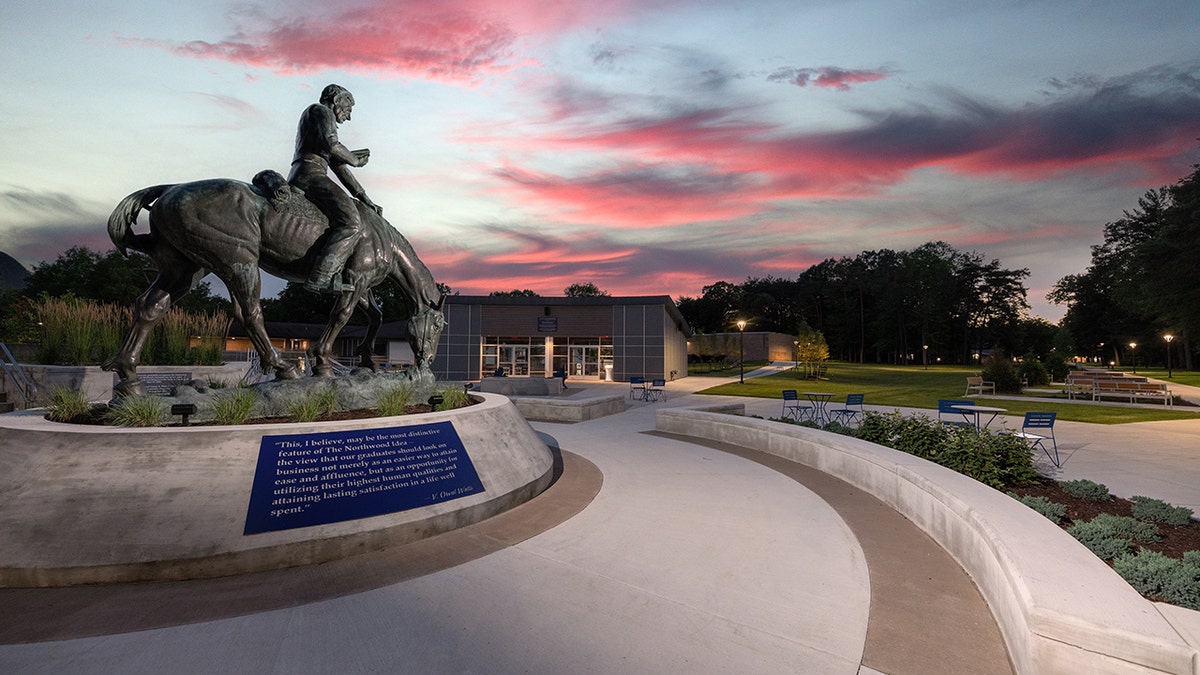 Statue on campus at Northwood university with academic building in background