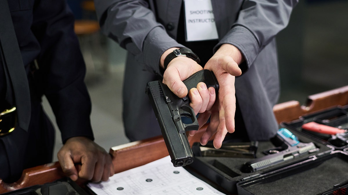 A person loads a handgun