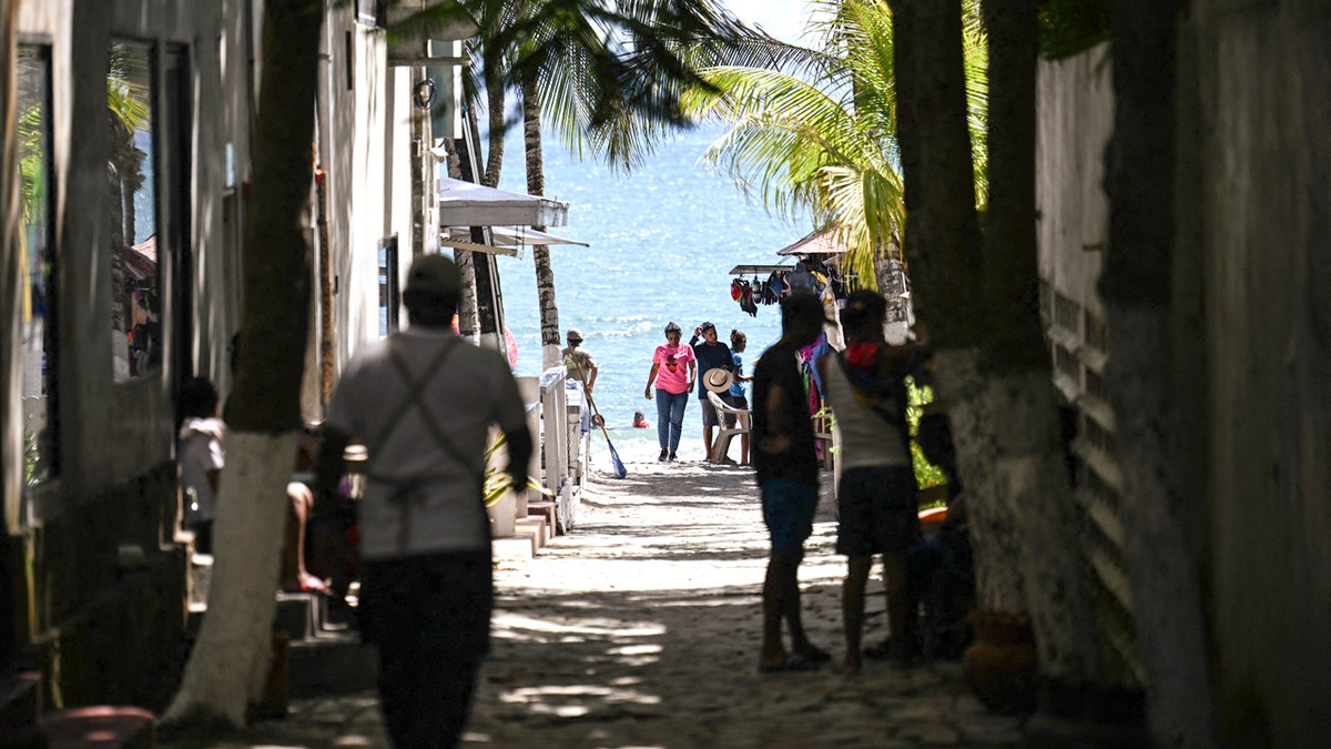 People walk at El Yaque Beach in Margarita Island, Nueva Esparta State, Venezuela