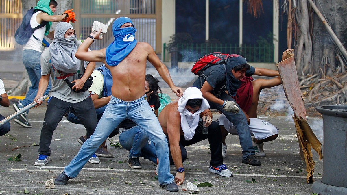 Protesters hurl objects in Caracas, Venezuela