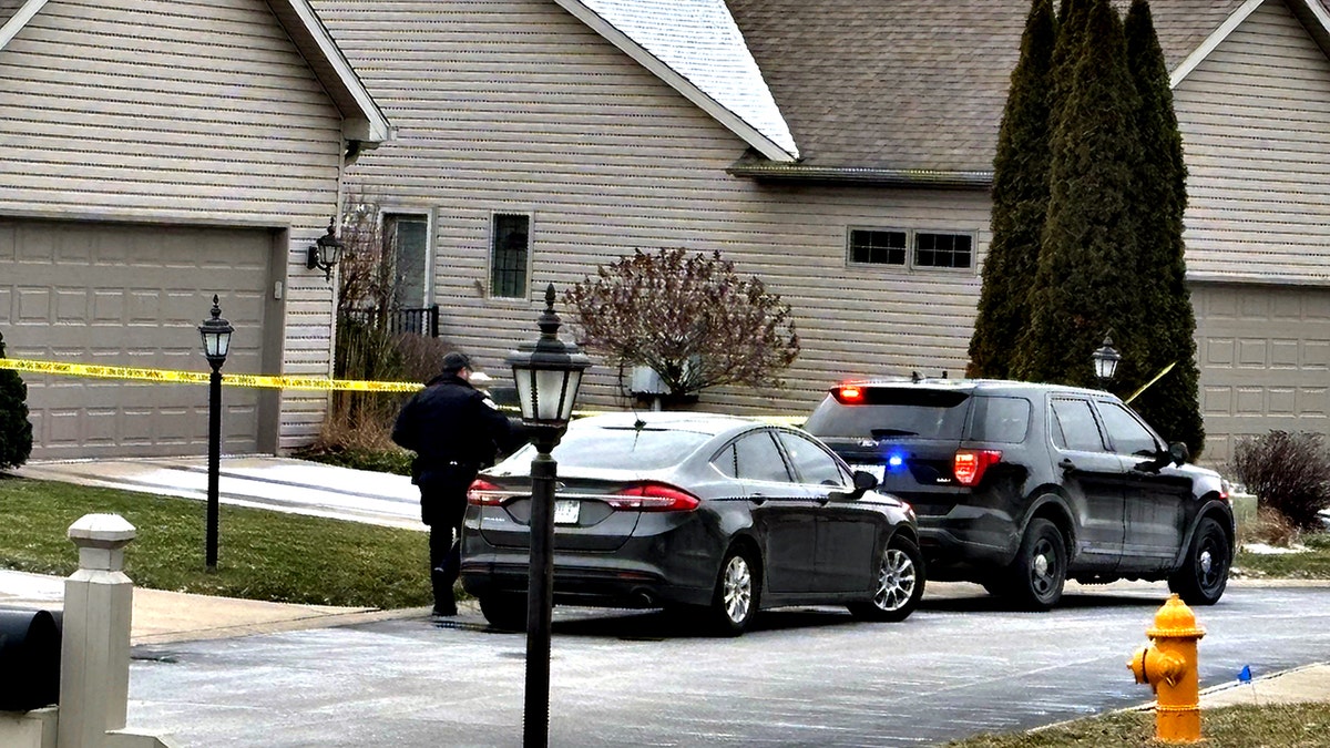 police officer outside home where shooting happened