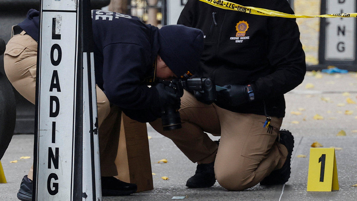 police take crime scene photos in Manhattan where Brian Thompson was killed