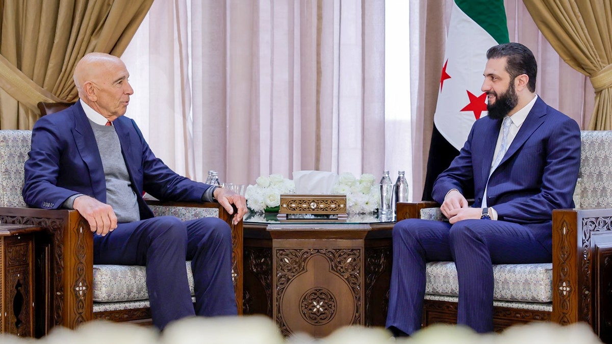 Two officials sit across from each other during a formal diplomatic meeting.