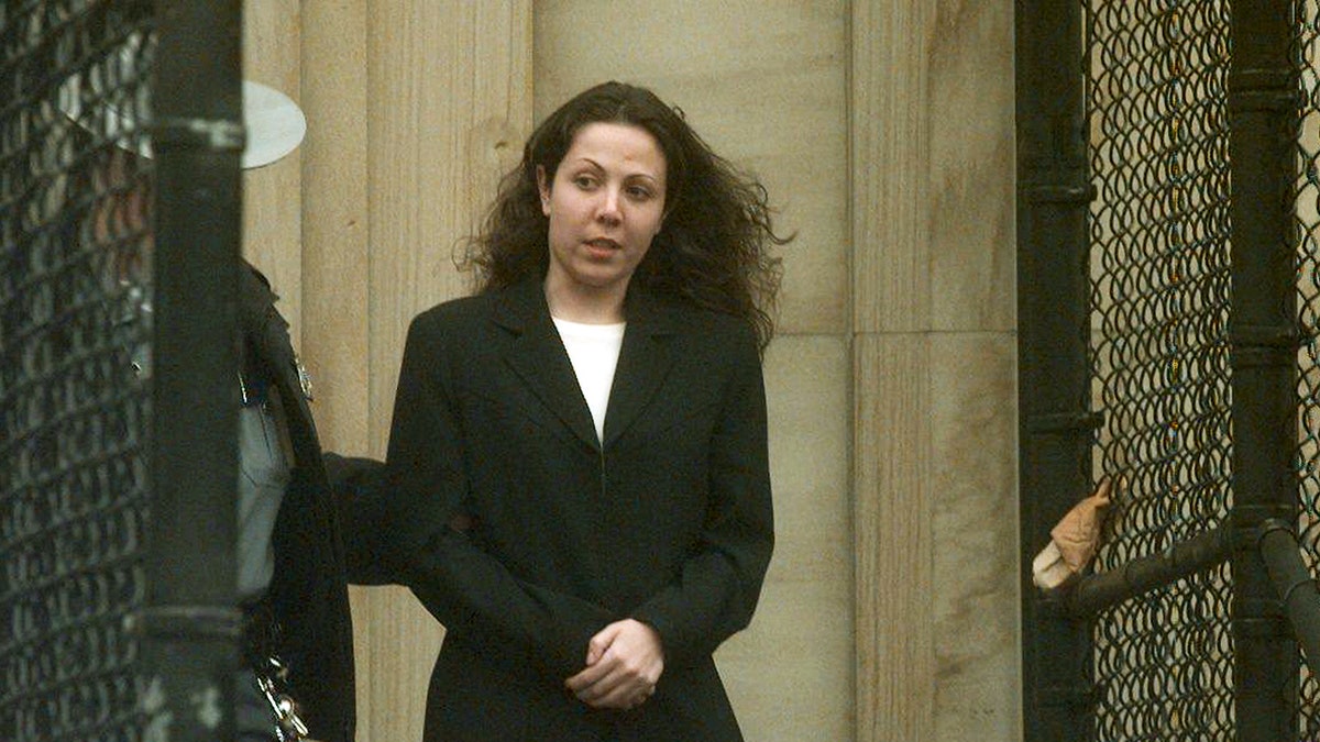 Amy Fisher wearing a black blazer and a white shirt.