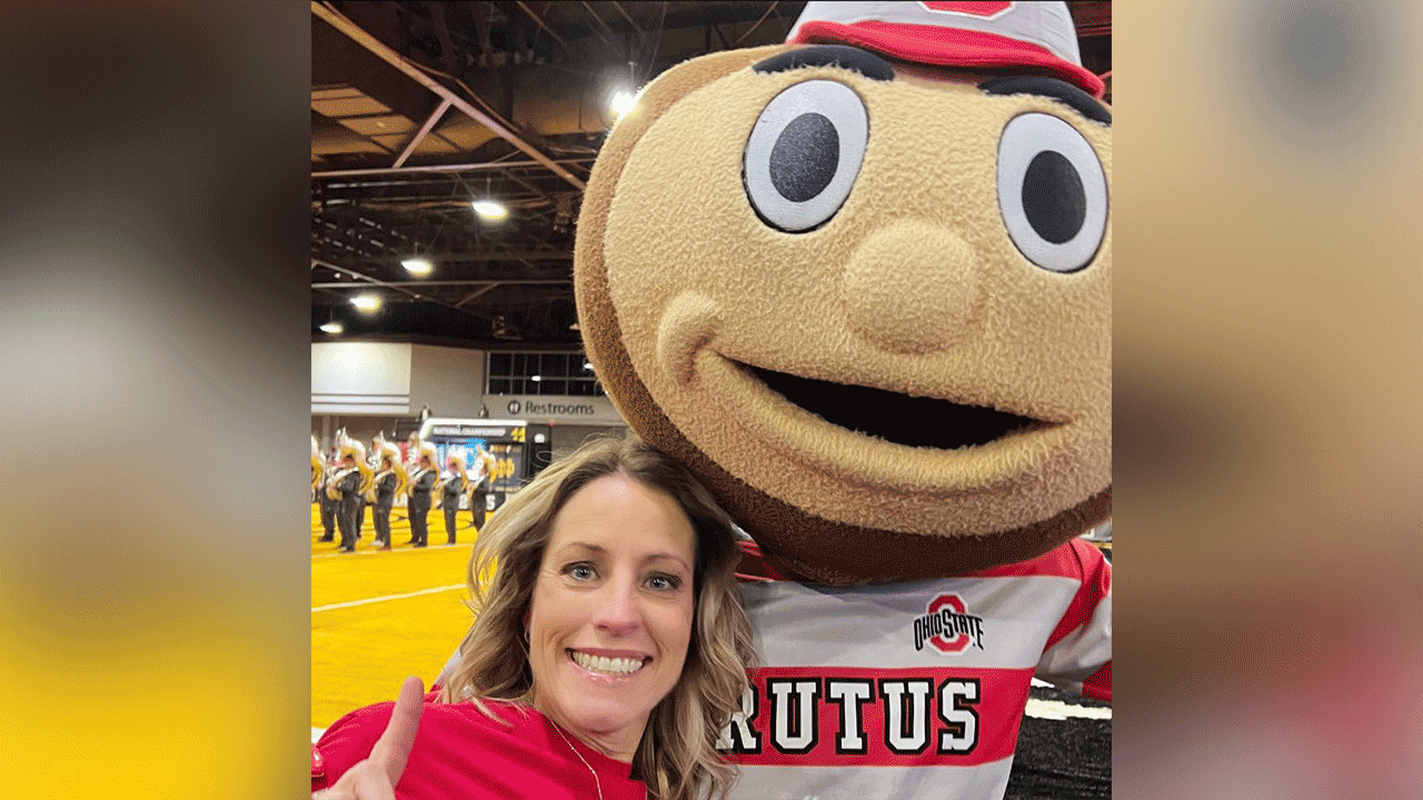 Courtney Shaw with mascot posing