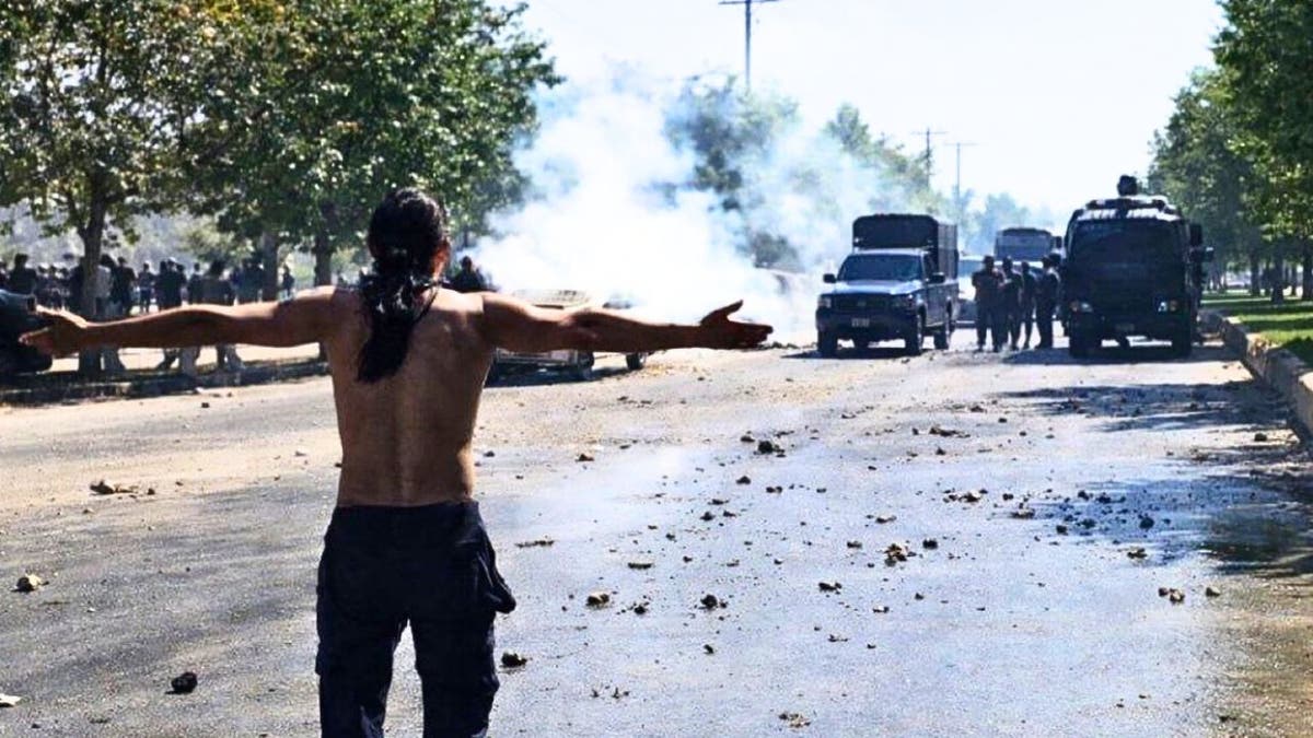 A protester faces Iranian security forces during clashes amid nationwide unrest, according to images released by the Iranian opposition group National Council of Resistance of Iran (NCRI)