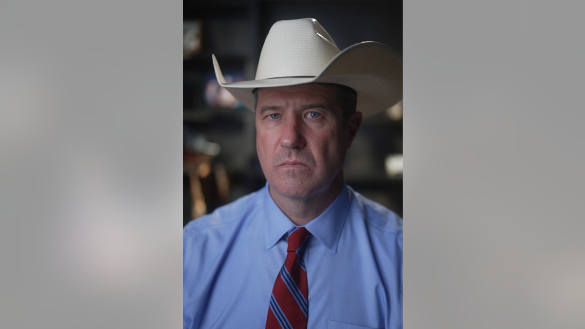 A close-up of James Holland in a cowboy hat.