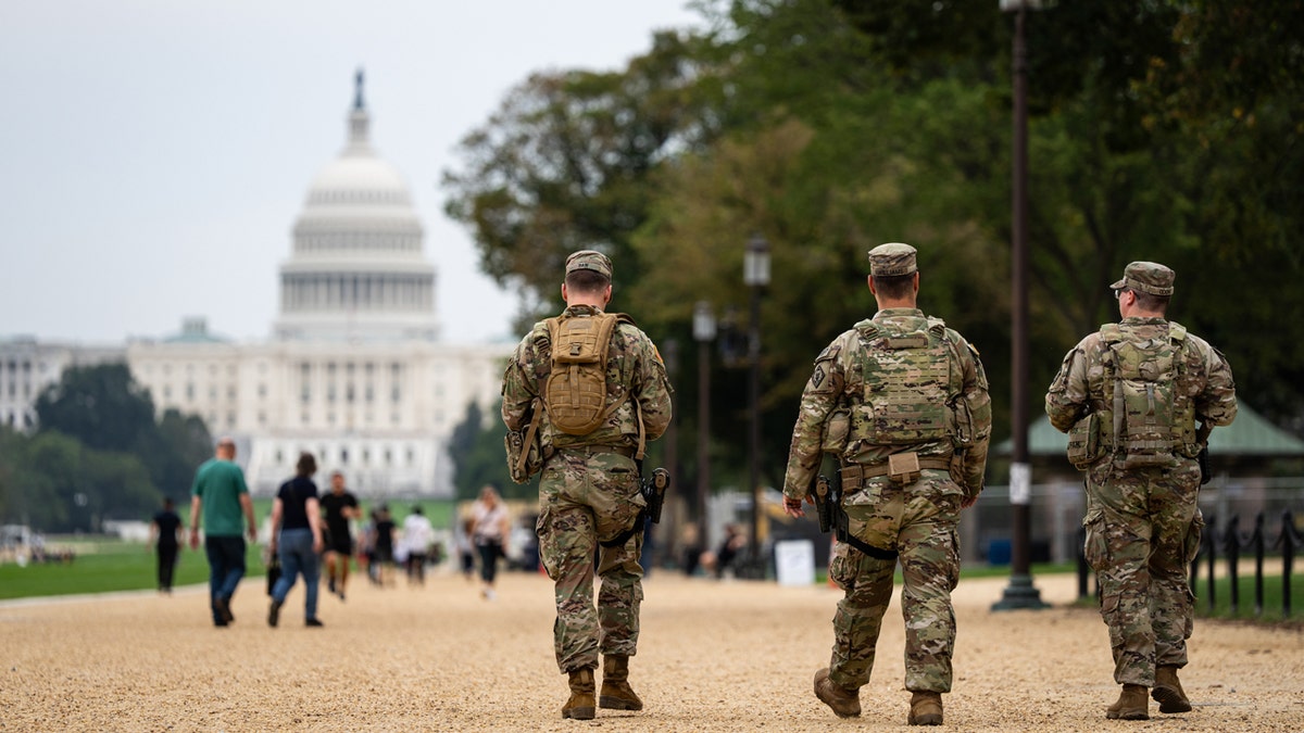 National Guard troops walk near Capitol Hill