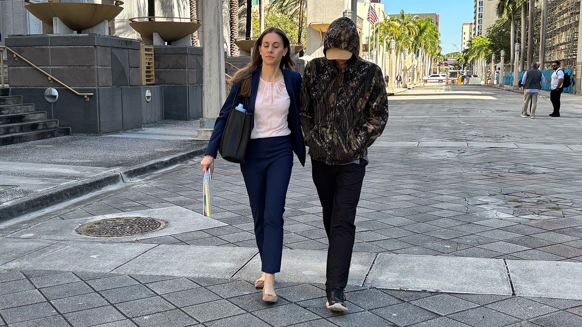 Anna Kepner’s stepbrother and his attorney walking outside of a Federal Court building in Miami.