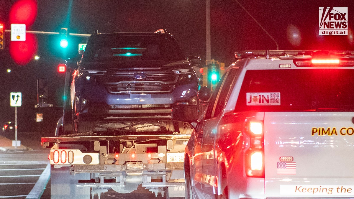 Nancy Guthrie's Subaru being towed on a flatbed truck while followed by a Pima County Sheriff vehicle
