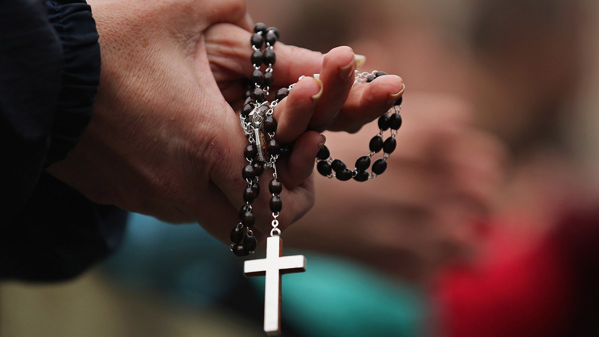 Woman holding rosary beads